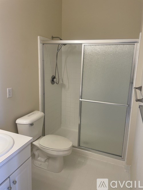 A white toilet and sink in a small bathroom.