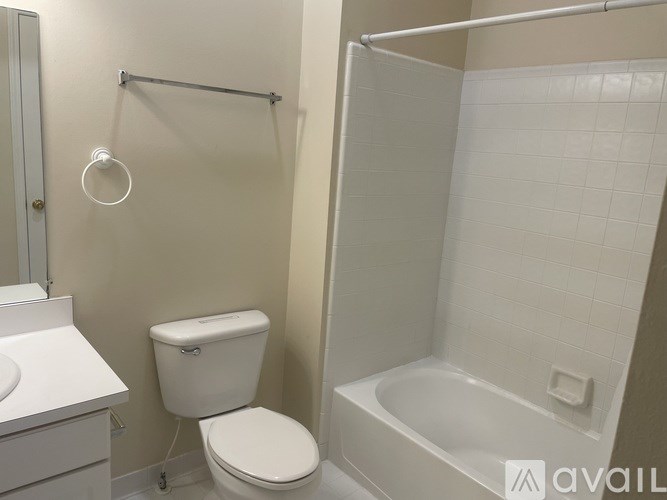 A white toilet and sink in a bathroom.