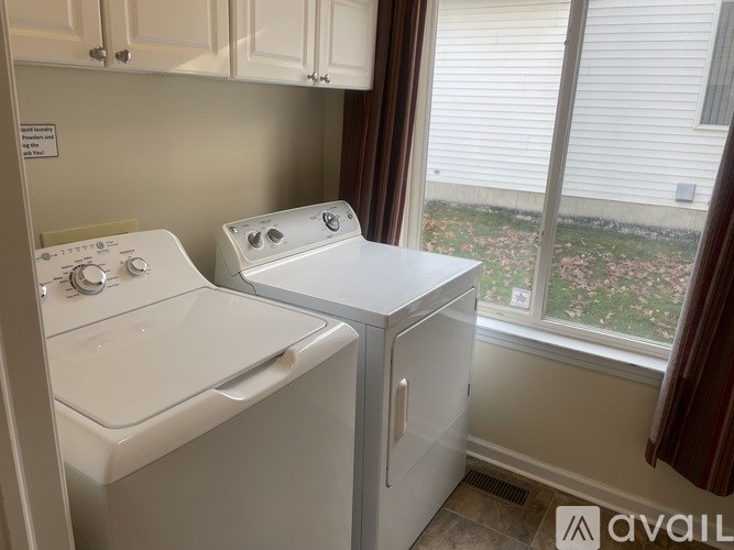 A small laundry room with a washer and dryer.
