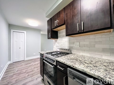 A kitchen with a granite countertop and a stove top oven.