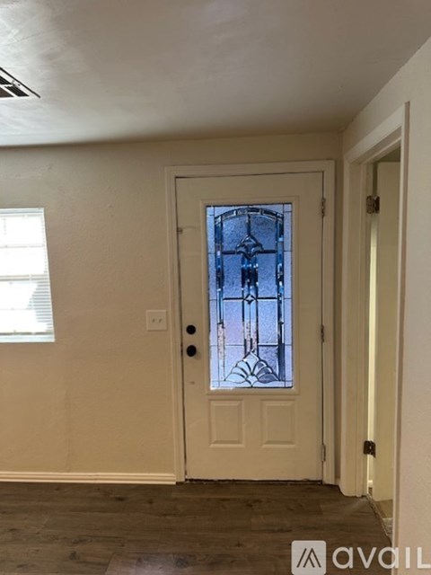 A white door with a glass window in the middle of it.