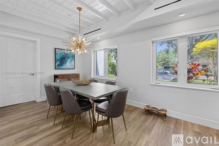 A dining room with a table and chairs.