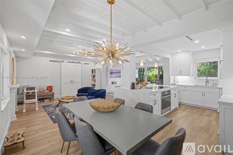 A modern dining room with a large table and chairs.
