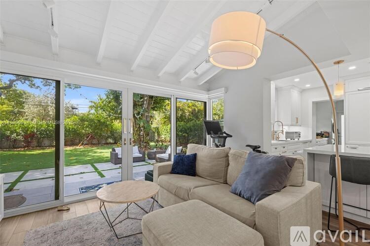 A living room with a couch, a table, and a lamp.
