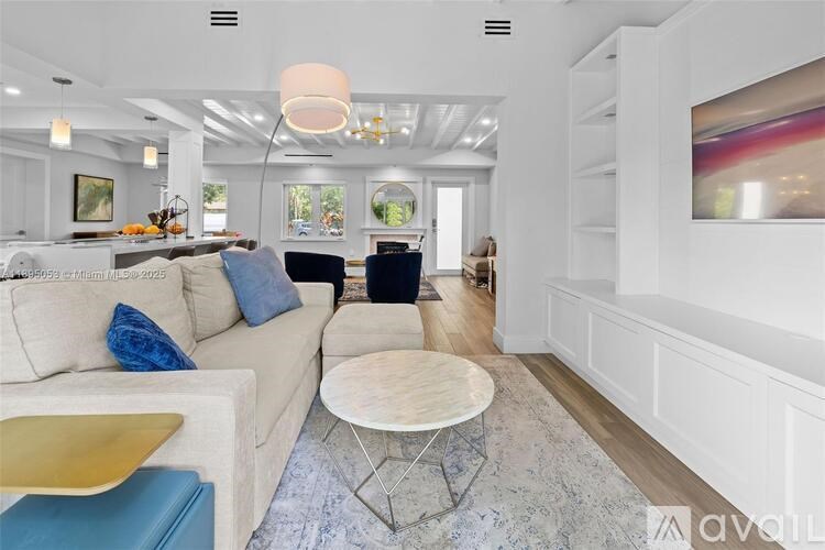 A modern living room with a white couch and a round table.