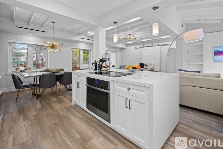 A modern kitchen with a dining table and chairs.
