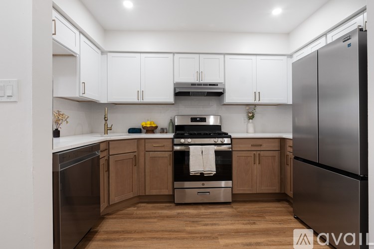 A kitchen with wooden cabinets and stainless steel appliances.