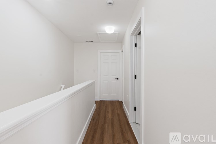 A long hallway with a door at the end.