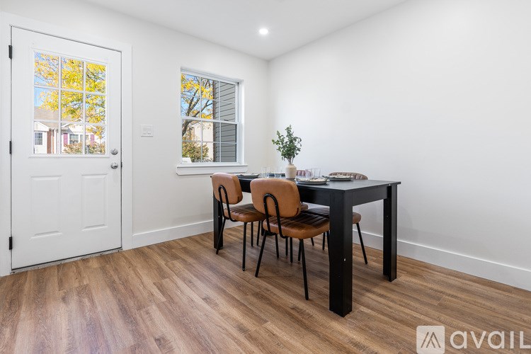 A room with a table and chairs and a window.