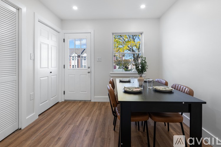 A dining room with a table set for four.