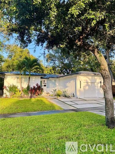 A house with a tree in front of it.