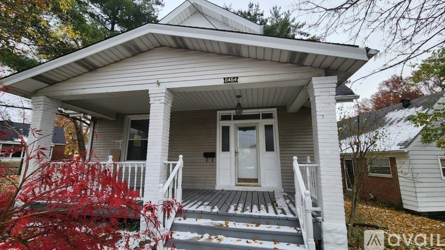 A house with a porch and a sign that says "AVAILABLE".