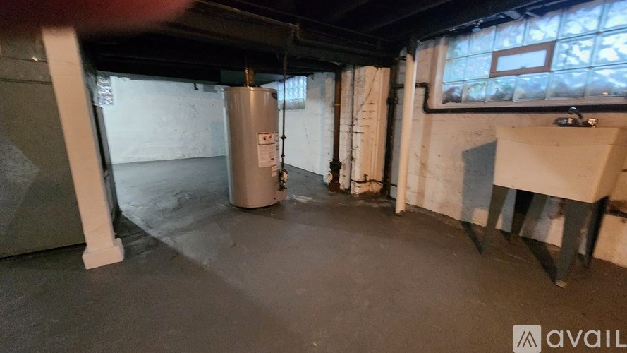 A room with a large window, a radiator, and a table.