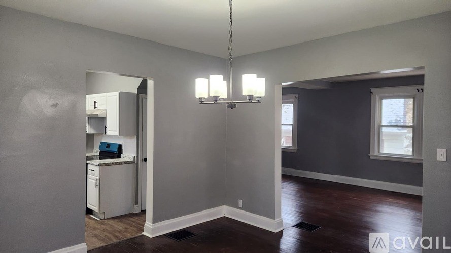 A kitchen with a refrigerator, cabinets, and a countertop is shown in this image.