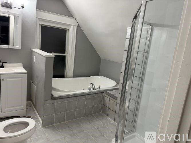 A bathroom with a toilet, sink, and bathtub.