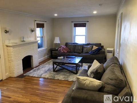 A living room with a fireplace and a couch.