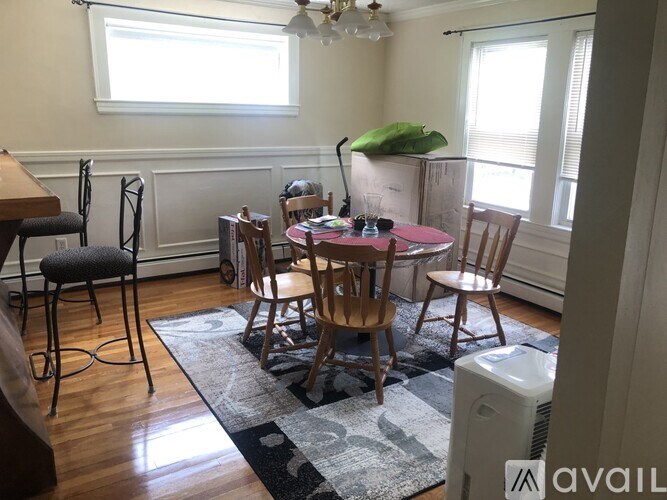 A dining room with a round table and chairs.