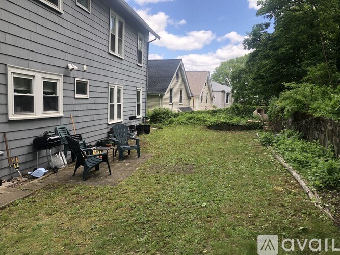 A backyard with a lawn and a shed.