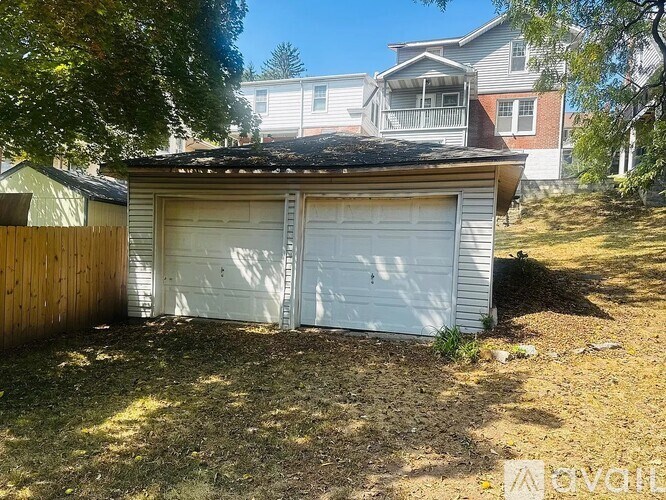 A house with a white garage door is for sale.