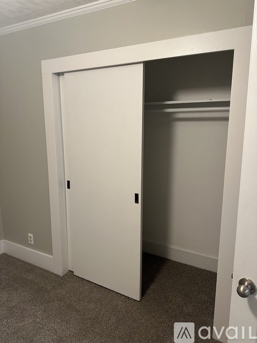 A white door is open to a small room.