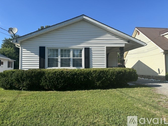 A house with a white exterior and a black window trim.