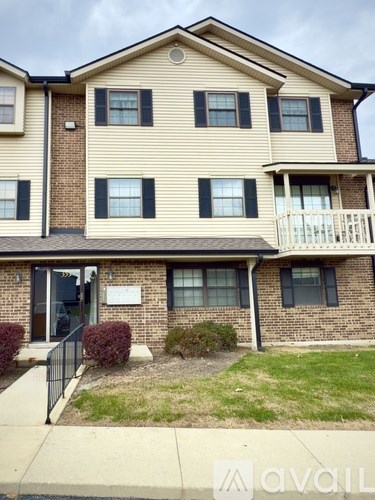 A two-story building with a balcony on the second floor.