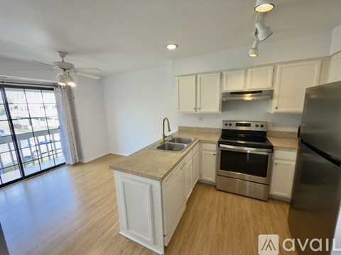 A kitchen with white cabinets and stainless steel appliances.