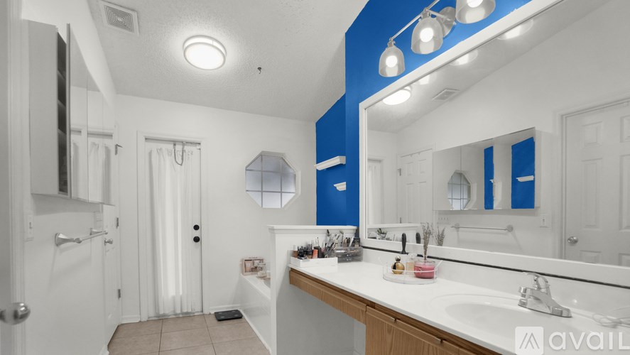 A bathroom with a white sink and a mirror.
