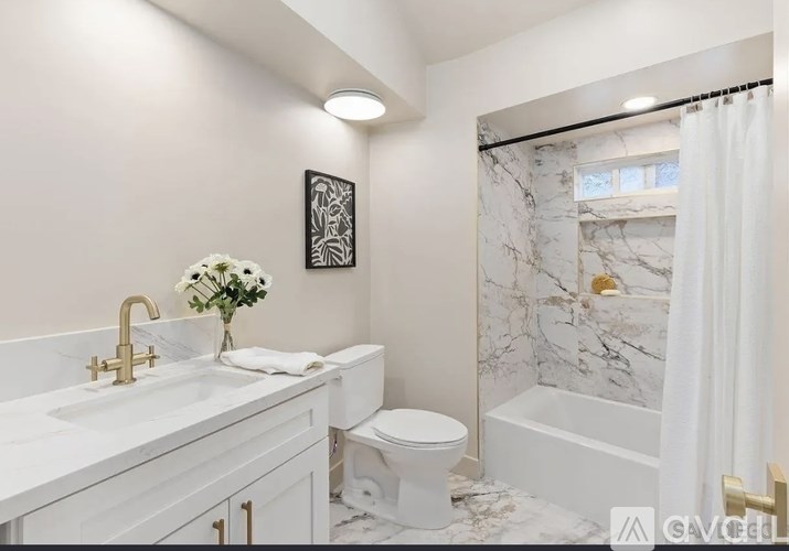 A bathroom with a marble shower and toilet.