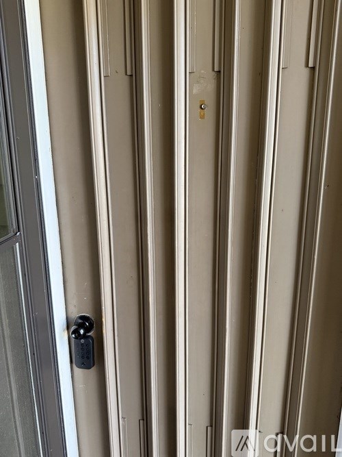 A white door with a black handle and a lock.