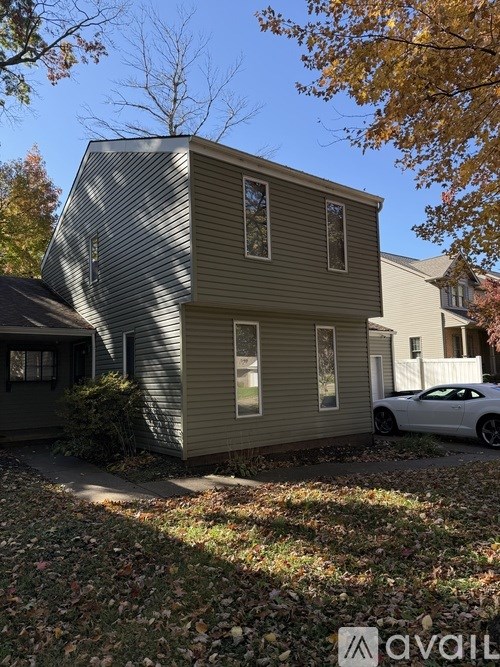 A house with a car parked in front of it.