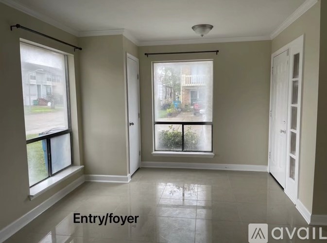 A room with a view of a street through the windows.