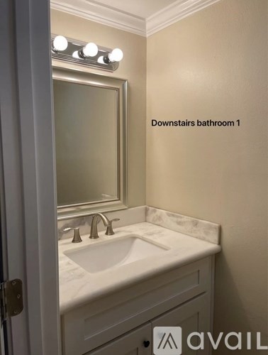 A bathroom with a sink and mirror.