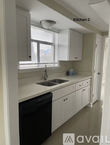 A kitchen with a sink and a window.