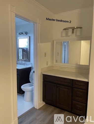A bathroom with a toilet and sink.