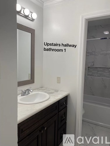 A bathroom with a sink and mirror in it.