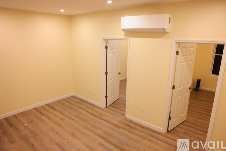 A room with a white air conditioner unit mounted on the wall.