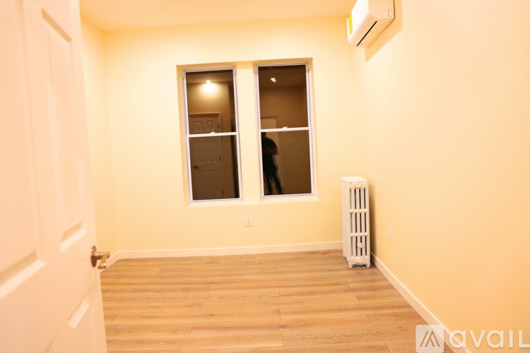 A room with a window and a white door.