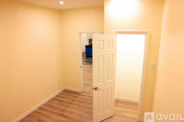 A room with a white door and a window.