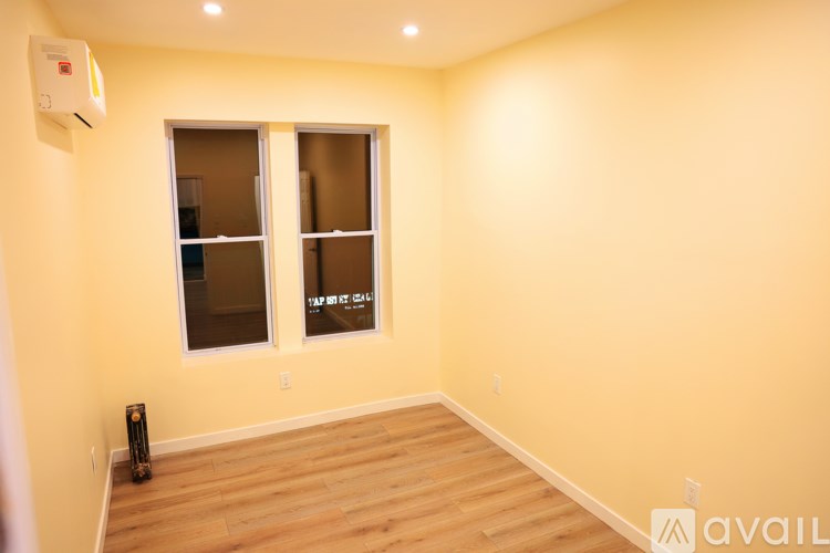 A room with a window and a speaker on the floor.