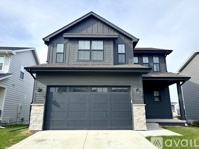 A two-story house with a garage is available for sale.