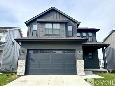 A two-story house with a garage is available for sale.