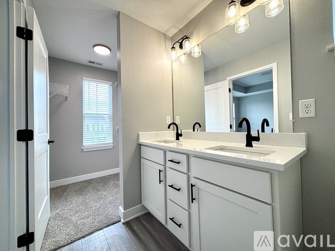 A bathroom with a white sink and a mirror above it.