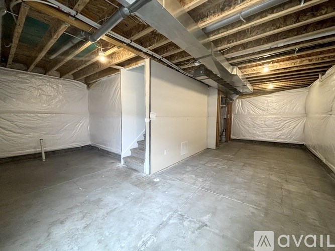 A room with a white door and walls covered in white insulation material.
