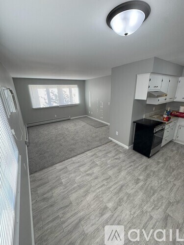 A kitchen with a black oven and white cabinets.