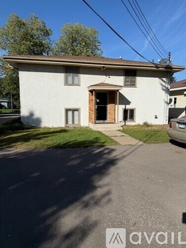 A house with a car parked in front of it.