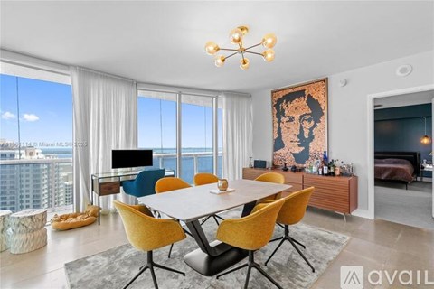 A modern dining room with a large table and chairs.