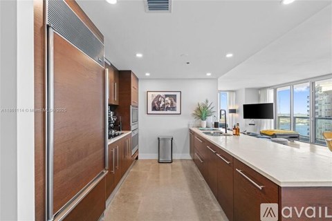 A modern kitchen with wooden cabinets and a white countertop.