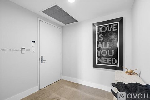 A room with a poster that says "Love is all you need".
