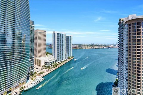 A view of a cityscape with a body of water and boats.